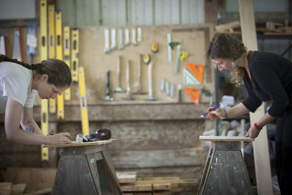 Two carpenters working in a workshop